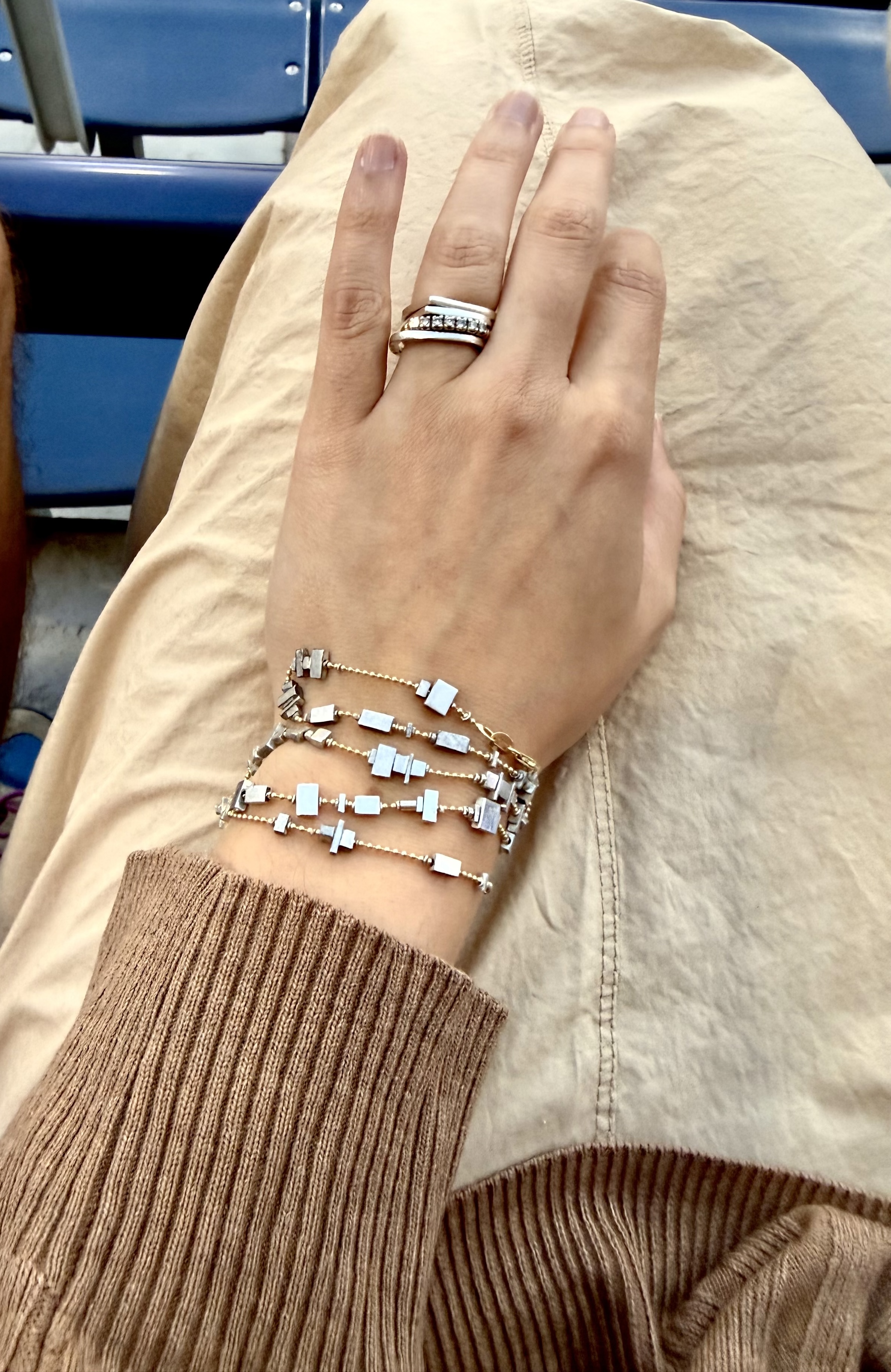Client wearing a ZULIE bracelet and necklace