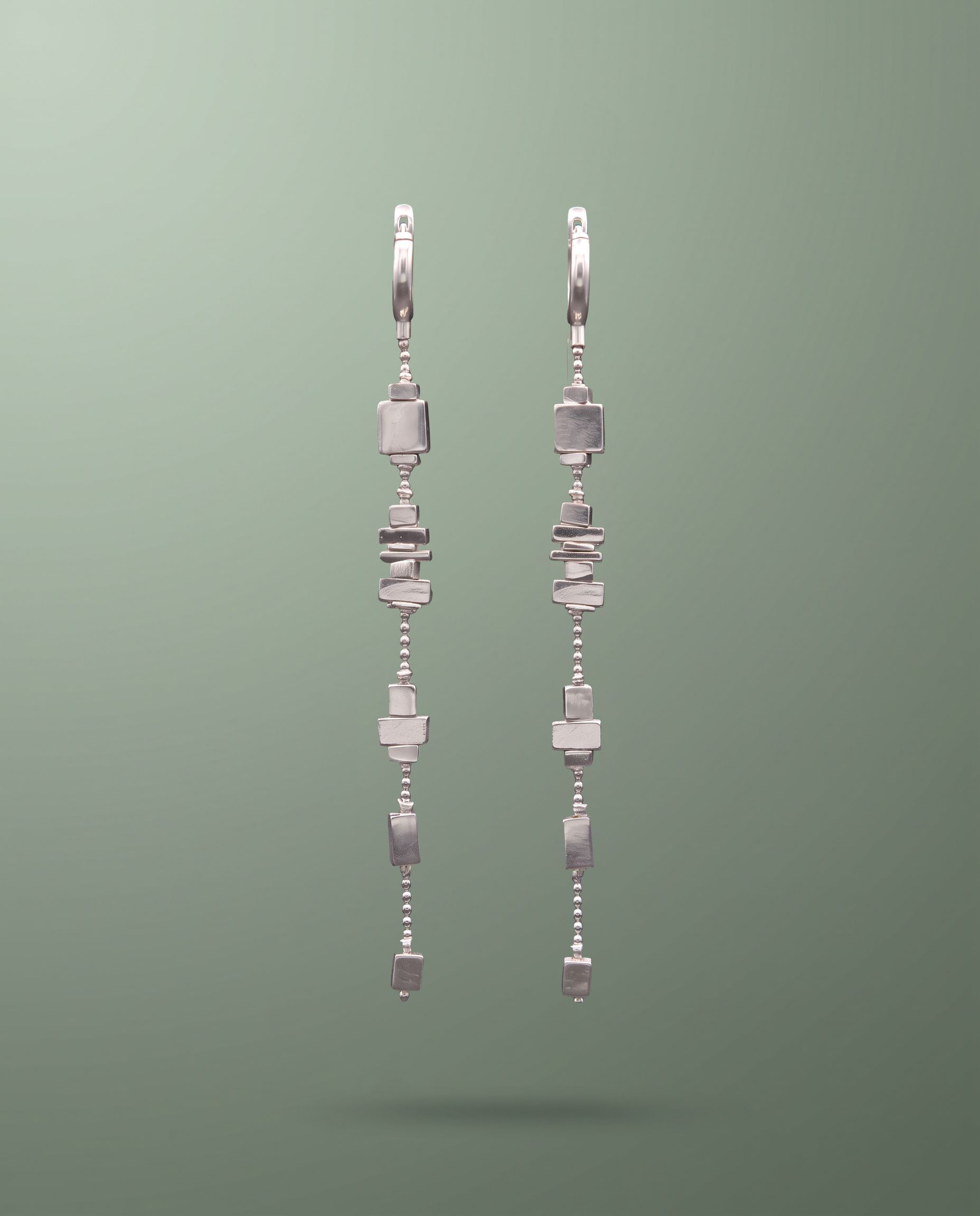 A pair of silver ZULIE sleep earrings